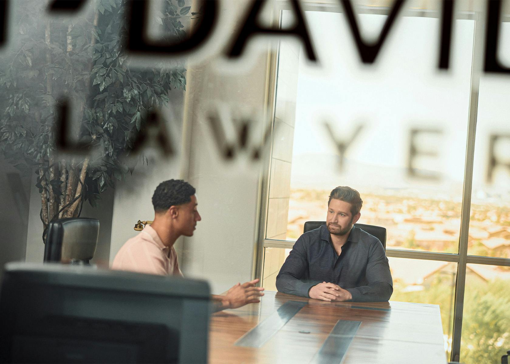 client and lawyer sitting at desk