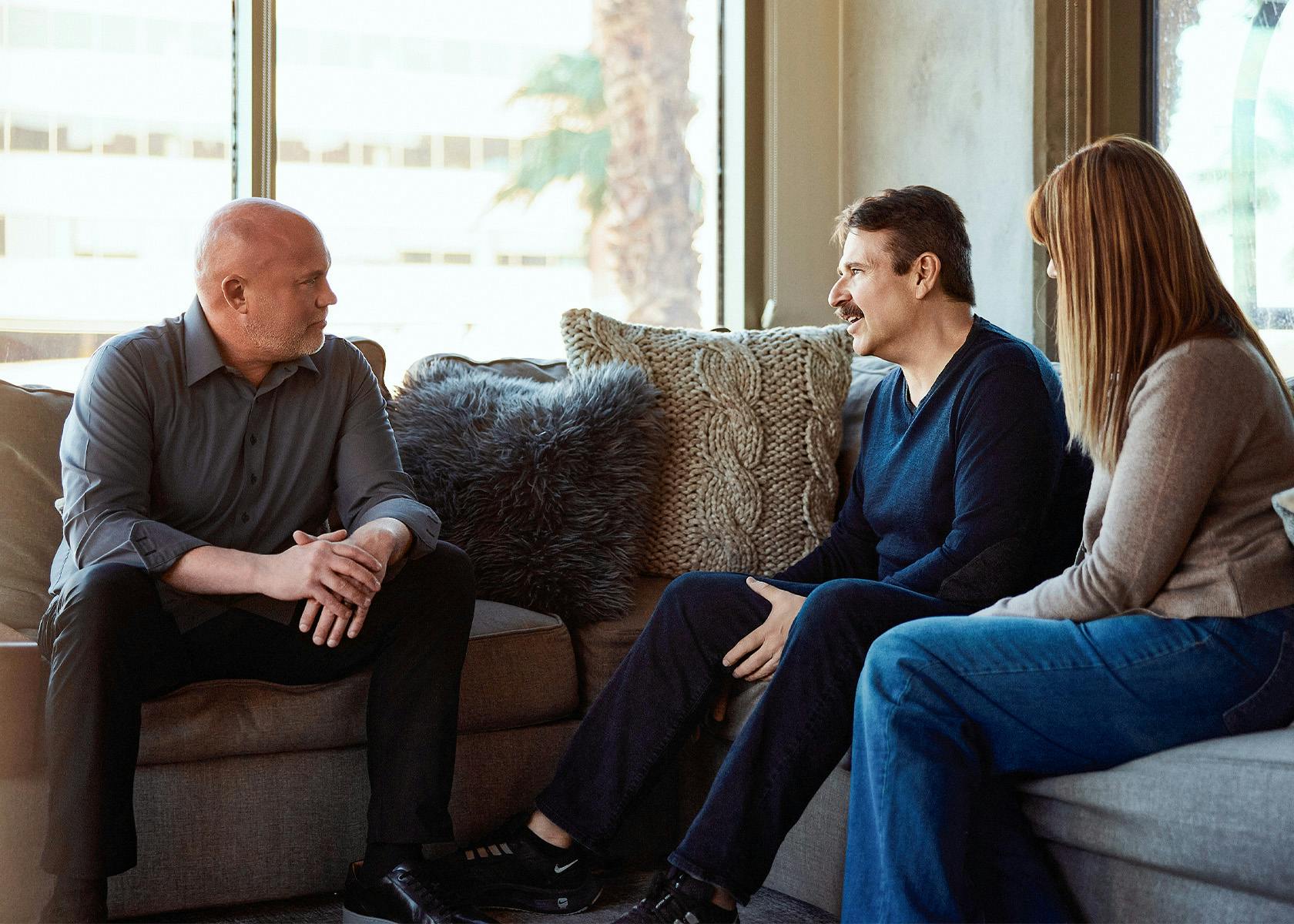 clients and lawyer sitting on couch