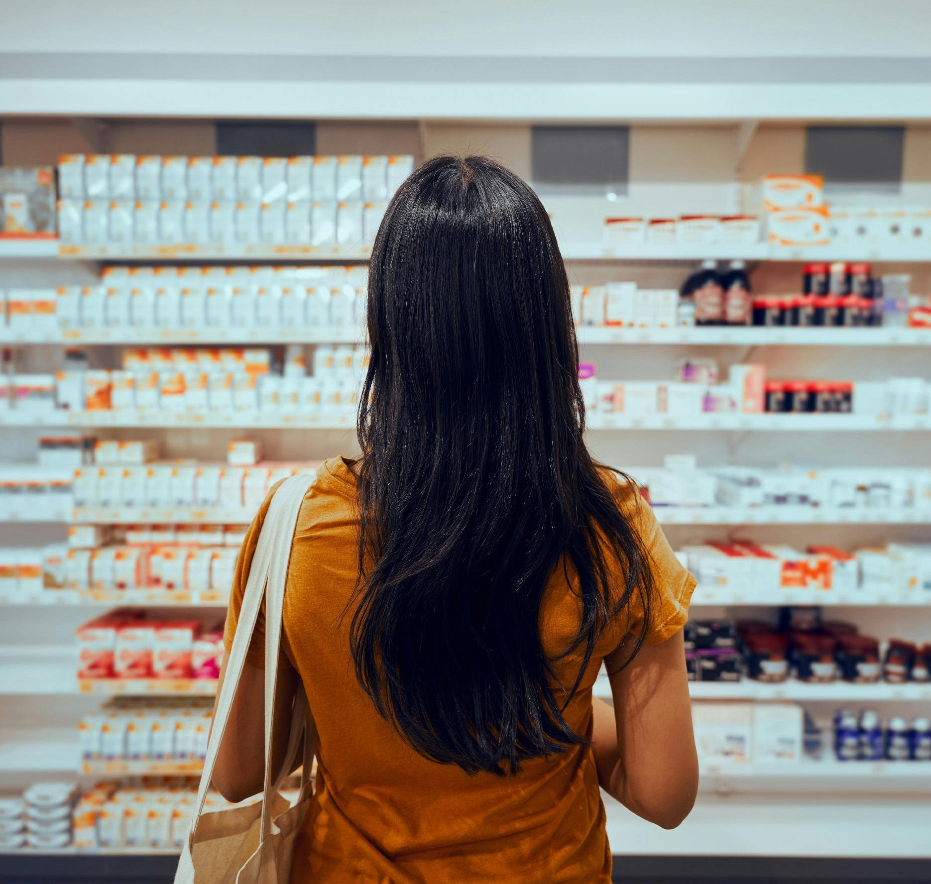 woman looking at pills