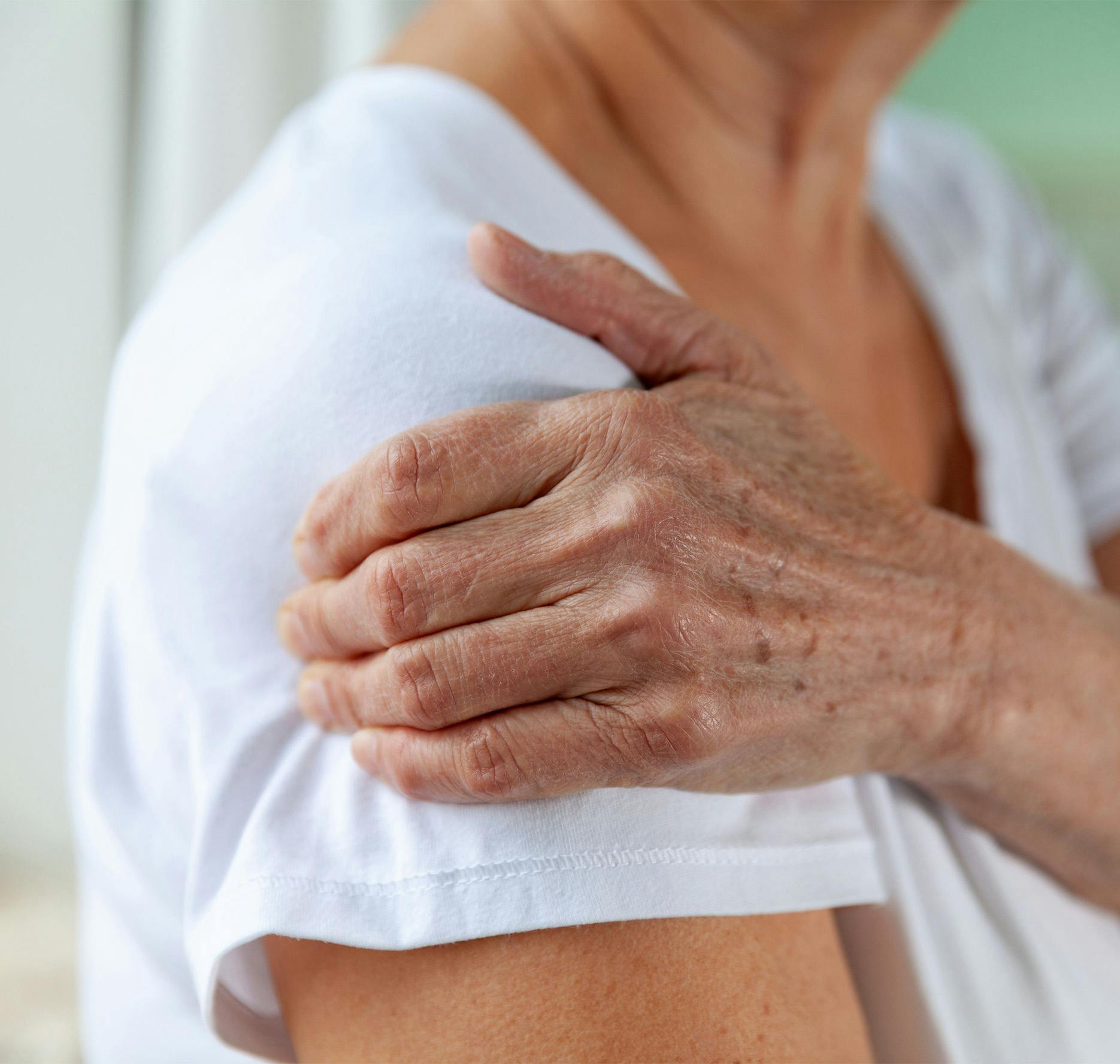 elderly woman holding arm