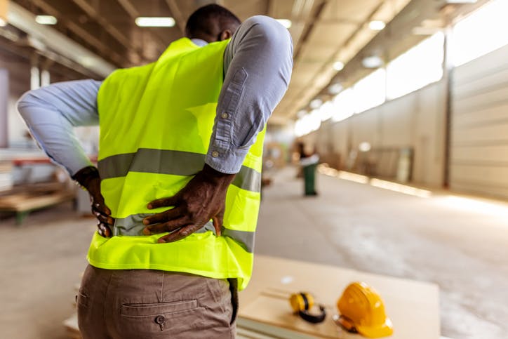 construction worker holding his lower back