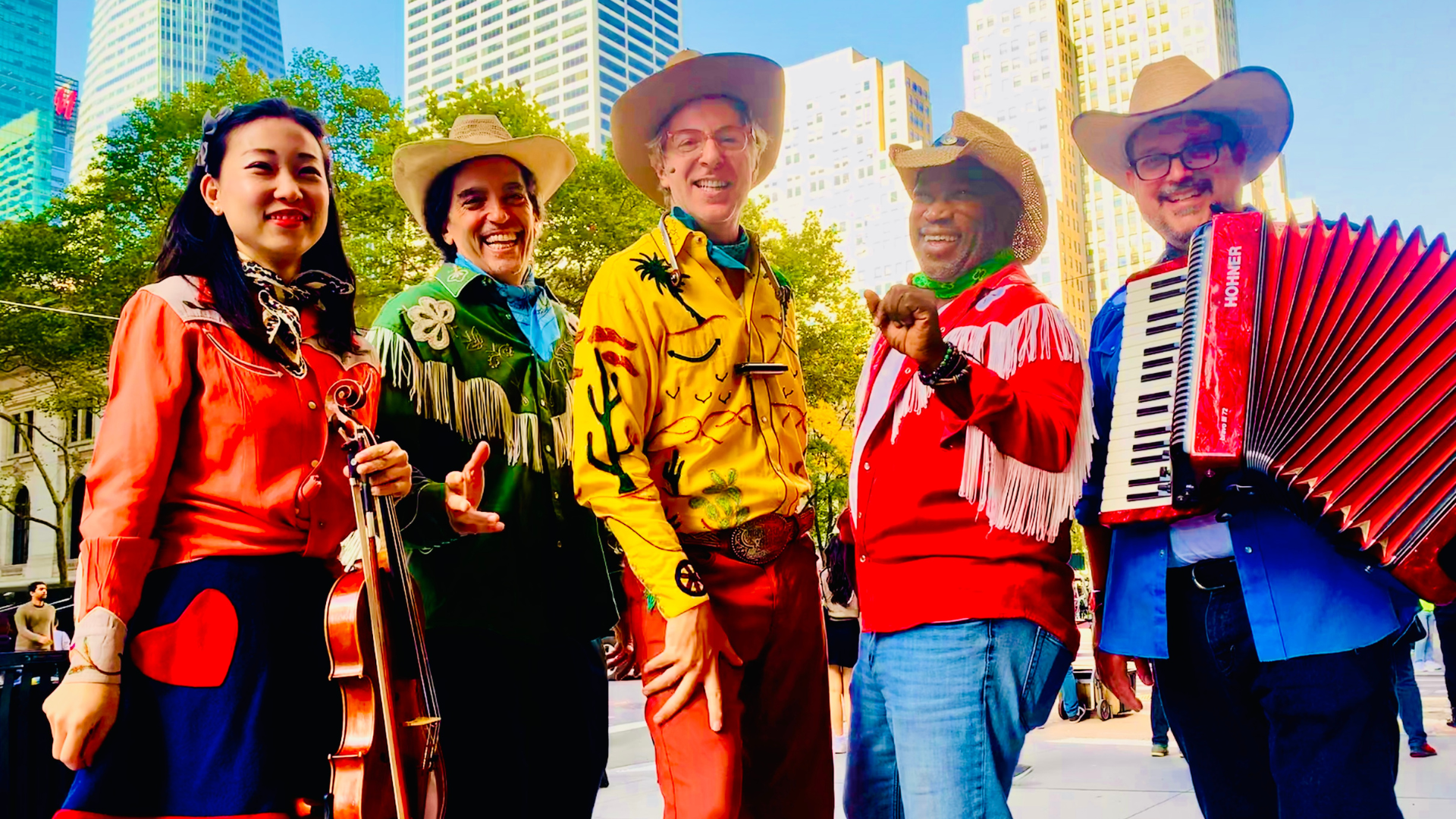 A musical group dressed in old time cowboy clothes stand together in New York City