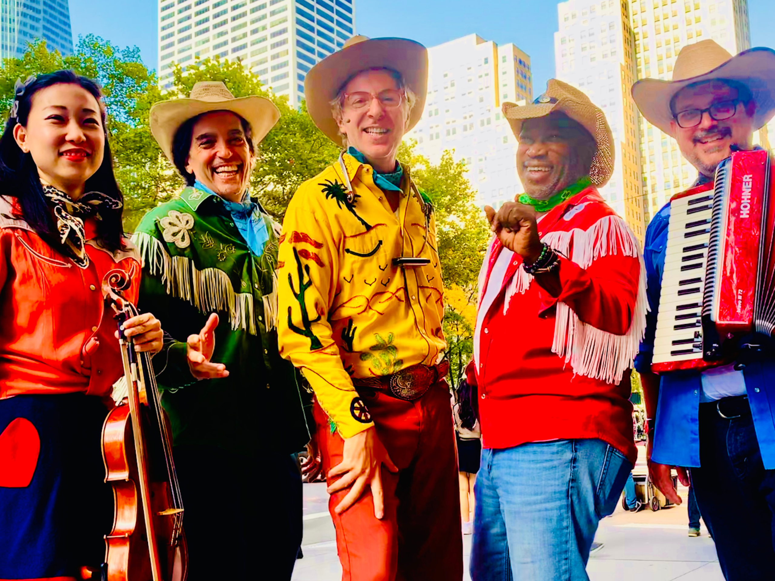 A musical group dressed in old time cowboy clothes stand together in New York City