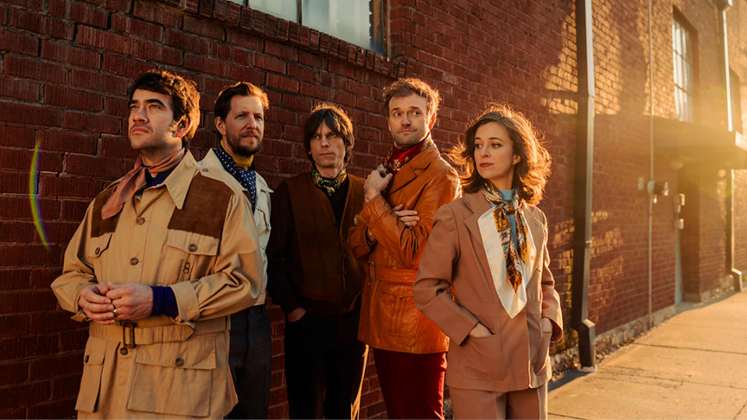 Punch Brothers pose outside a building in beautiful light. Photo by Josh Goleman