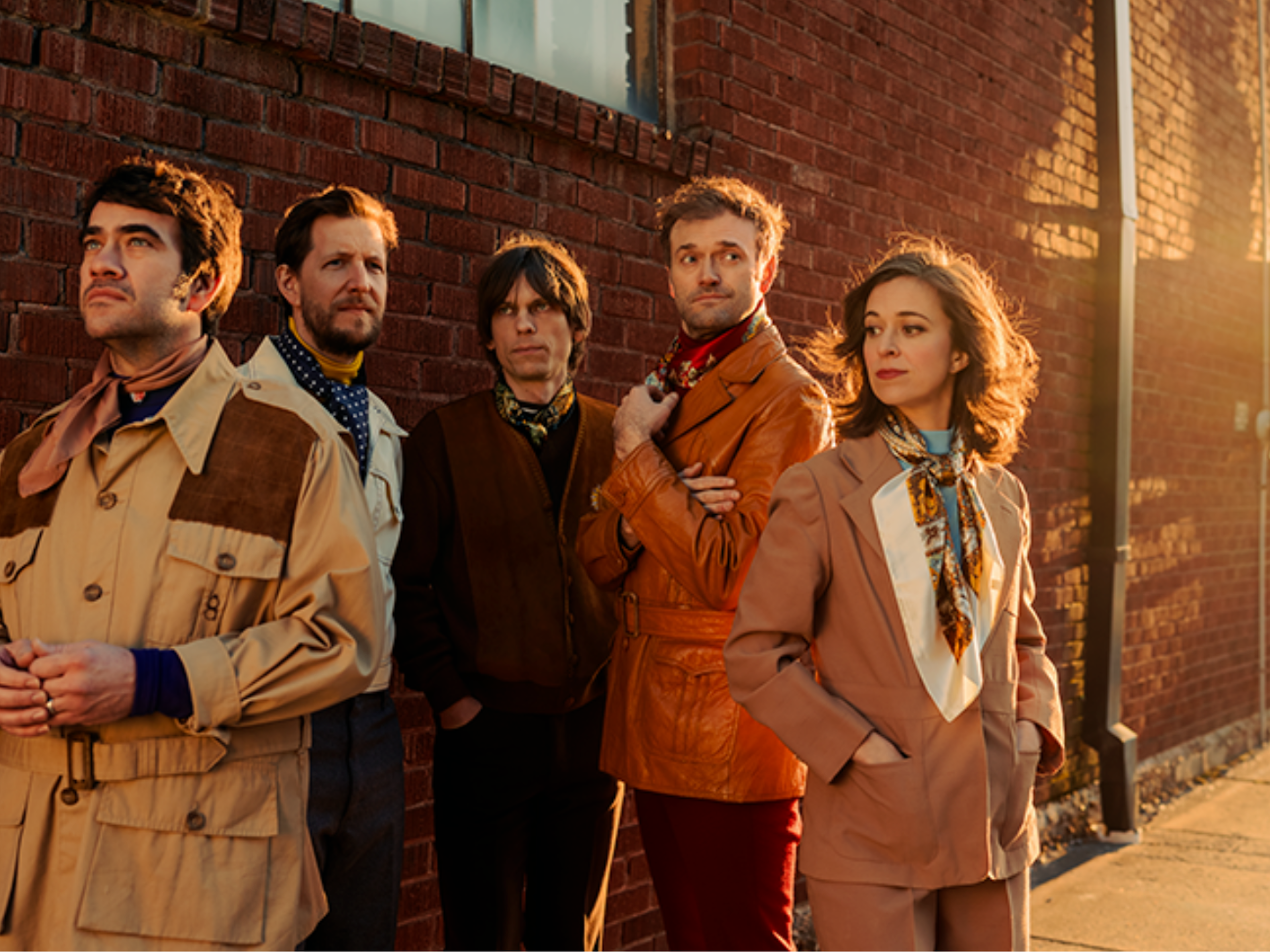 Punch Brothers pose outside a building in beautiful light. Photo by Josh Goleman