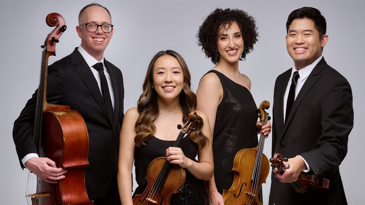 A quartet of musicians hold a cello, two violins, and a viola.
