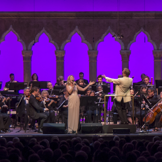 Kelli O'Hara singing onstage with Orchestra of St.Luke's in front of an audience