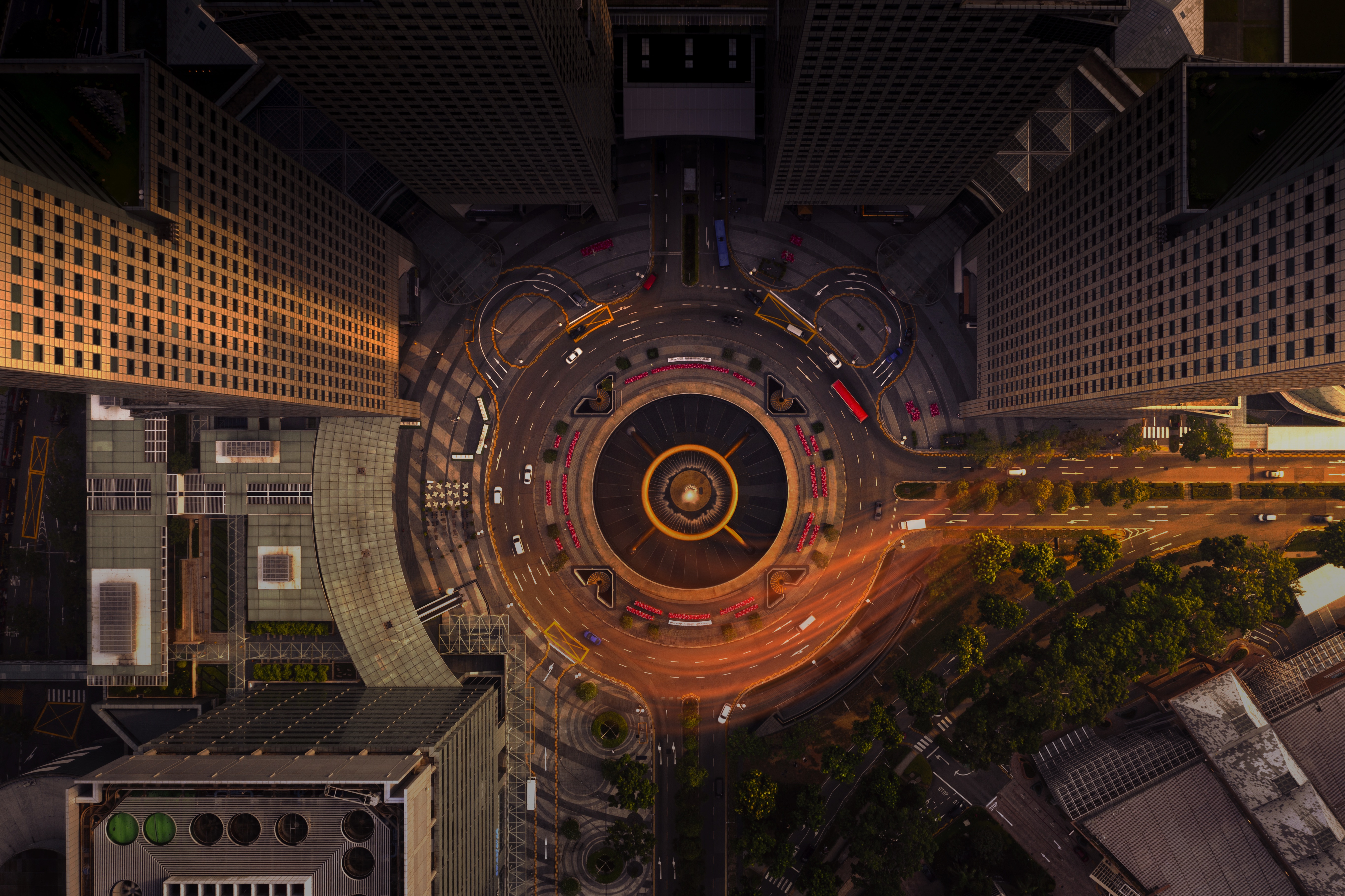 An aerial view of a busy roundabout, surrounded by buildings
