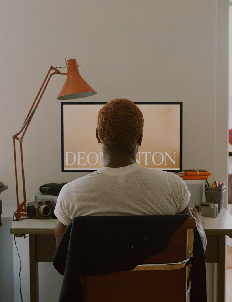 Person working at a desk on a computer as part of a digital web design team