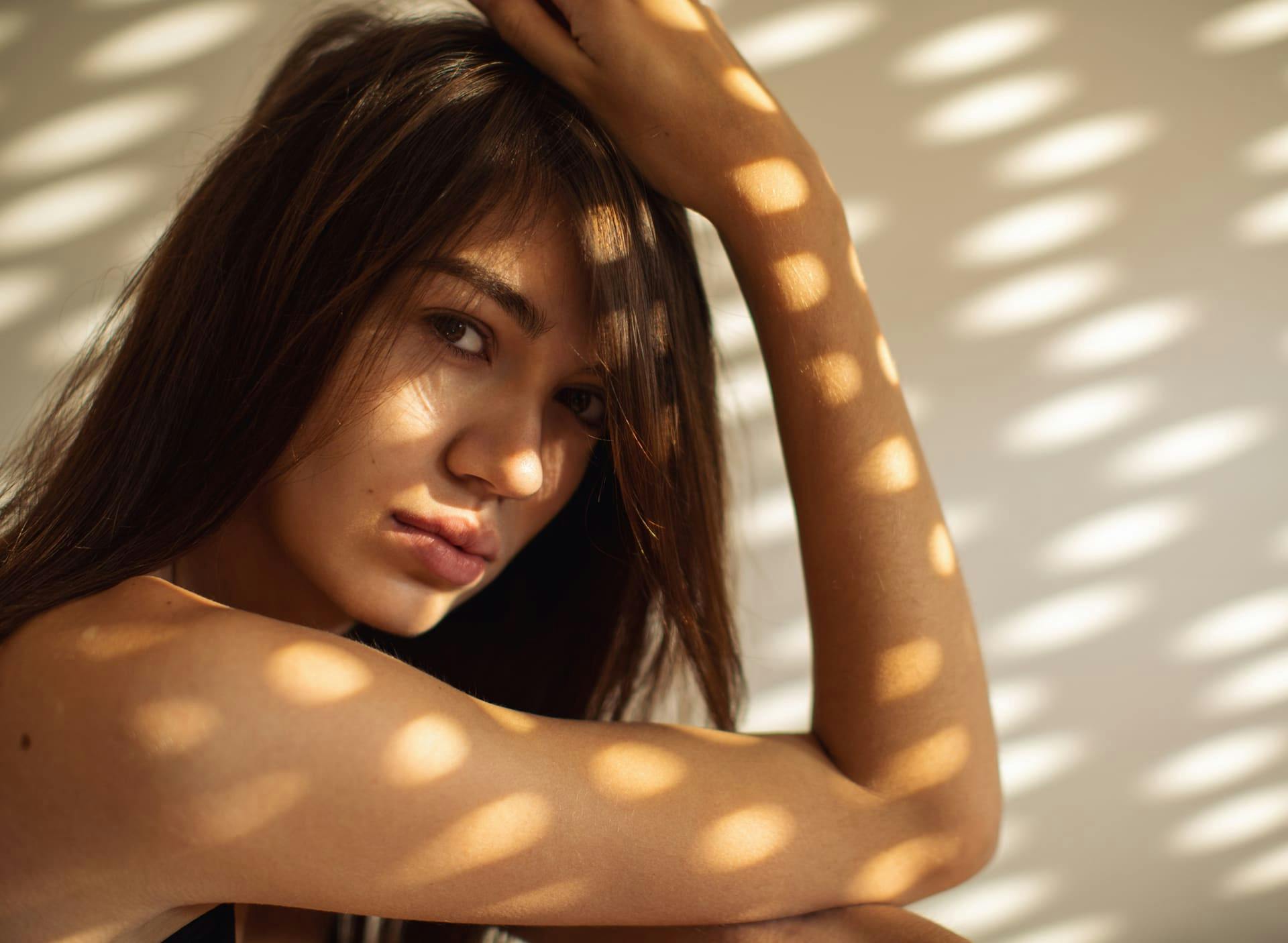 woman resting her elbow on her knee