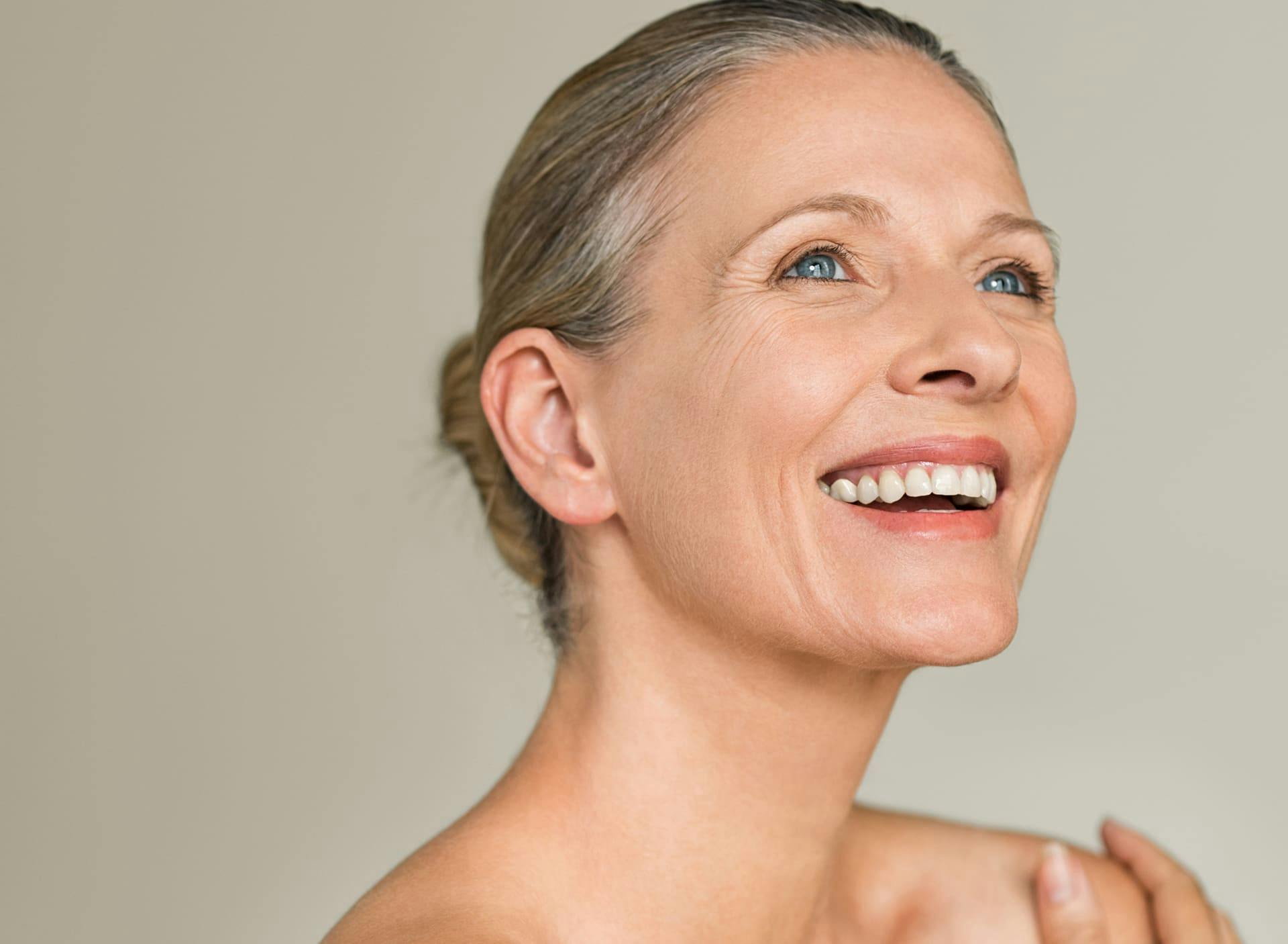 woman smiling with her hair tied in a bun