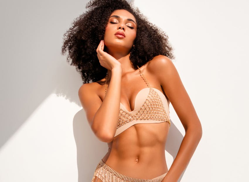 woman in afro and golden bikini