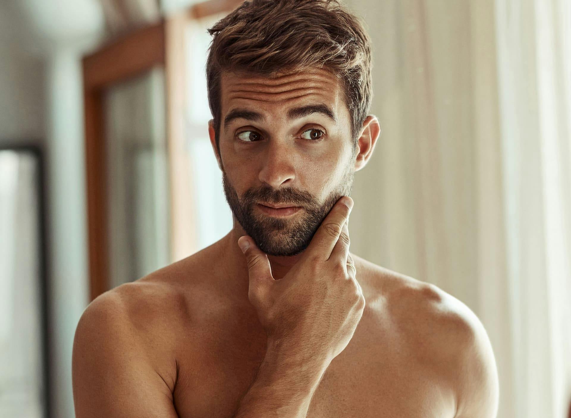 man touching his beard