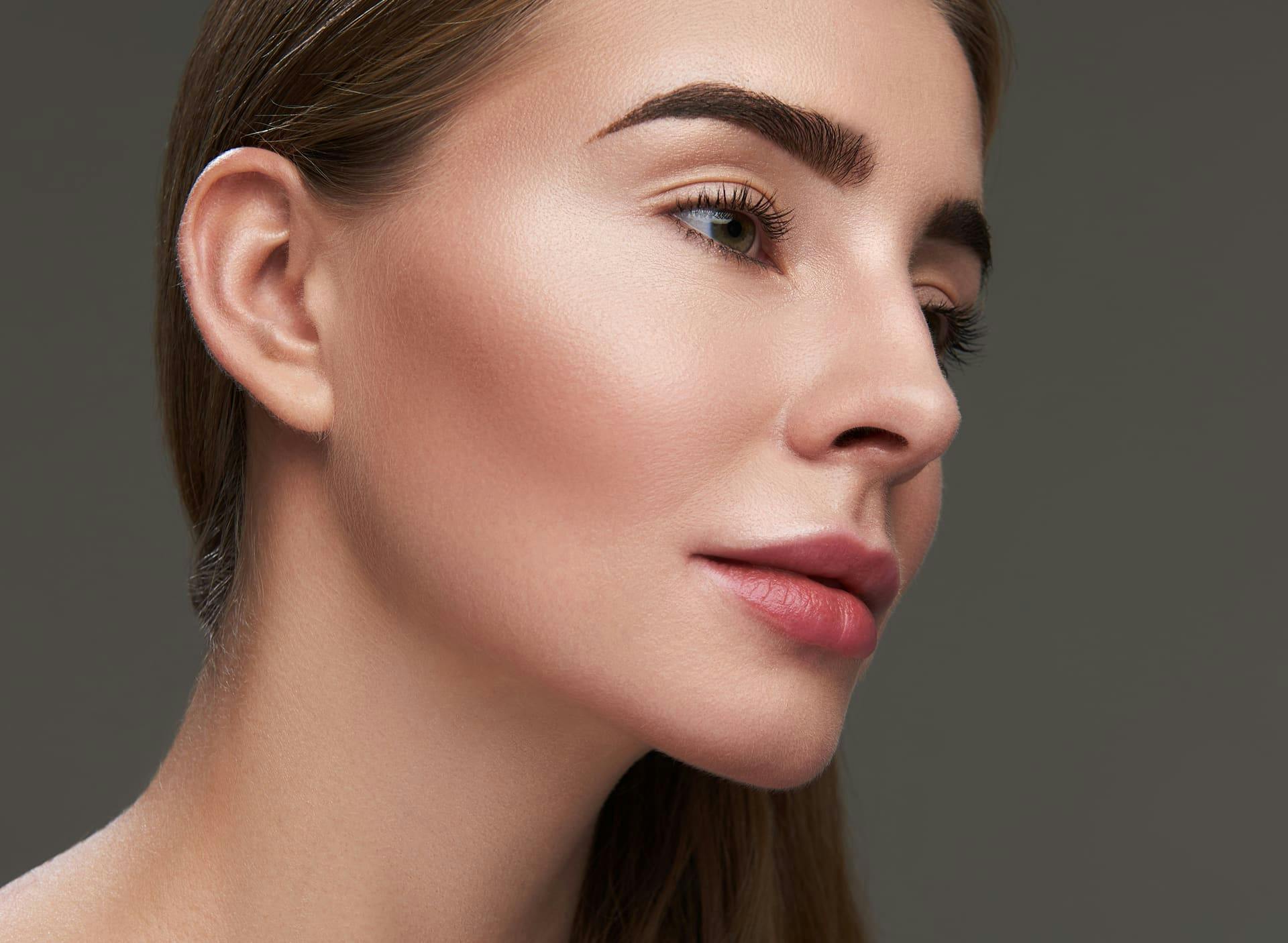 woman with thick eyebrows looking to the right