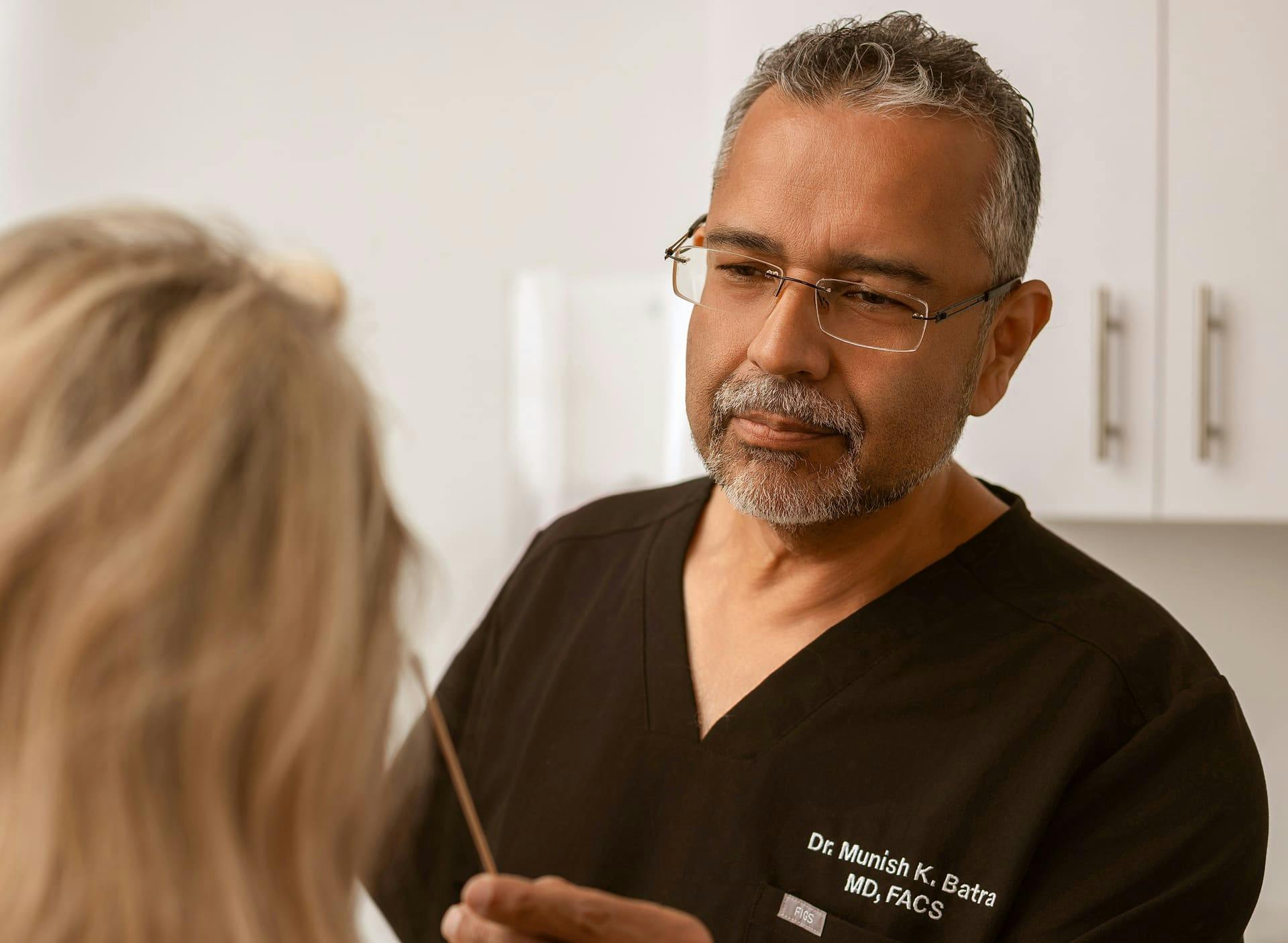 Dr. Munish Batra examining patient's eye