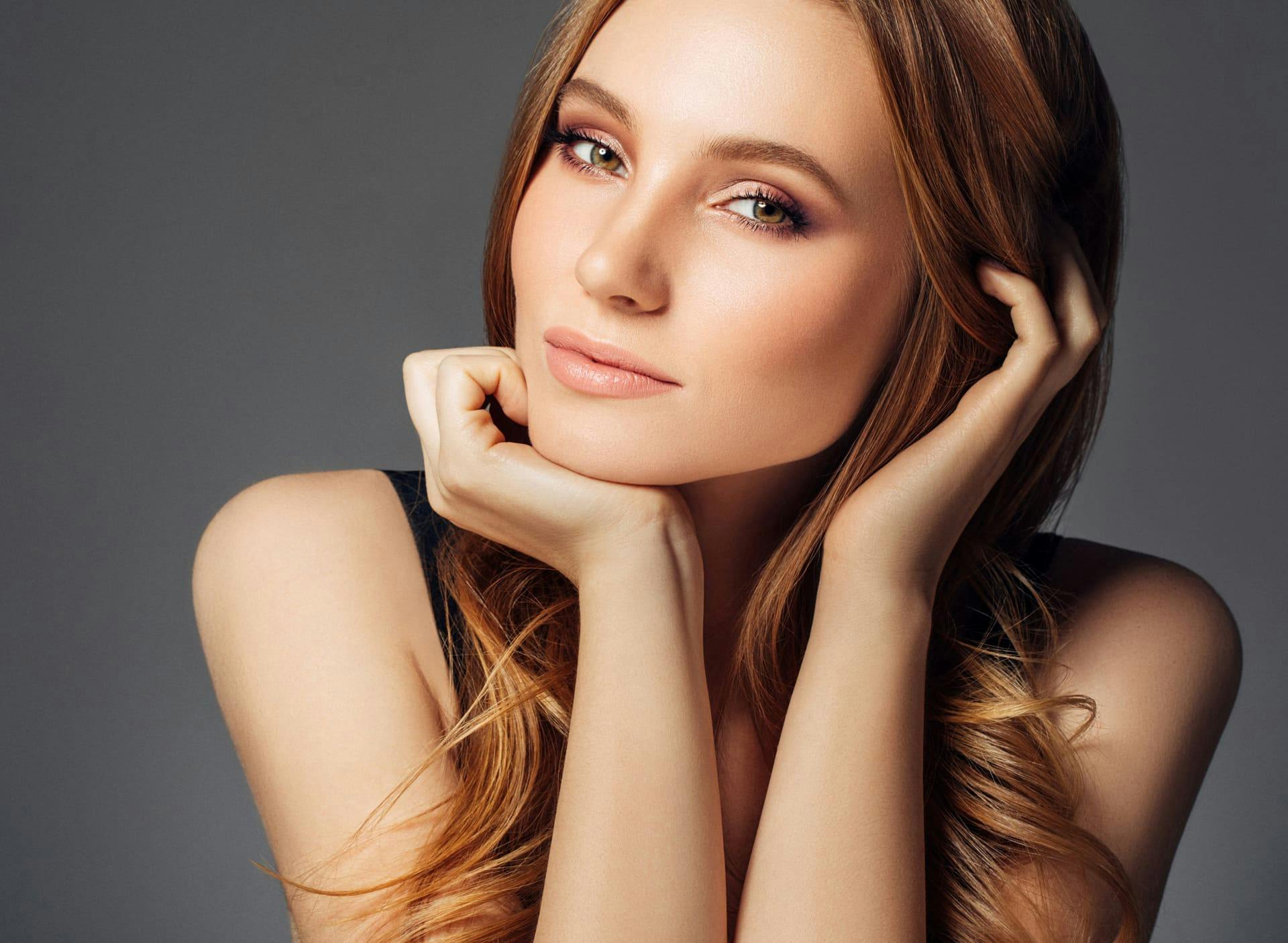 woman resting her chin on the palm of her hand