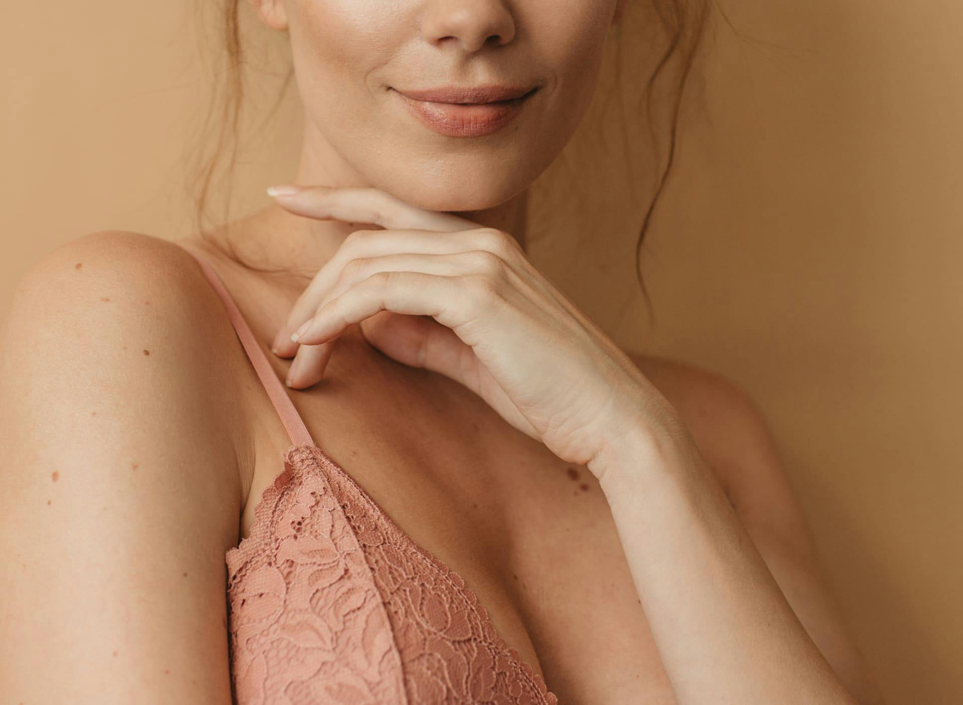 woman's lower face with her hand under her chin