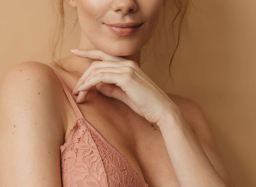 woman's lower face with her hand under her chin