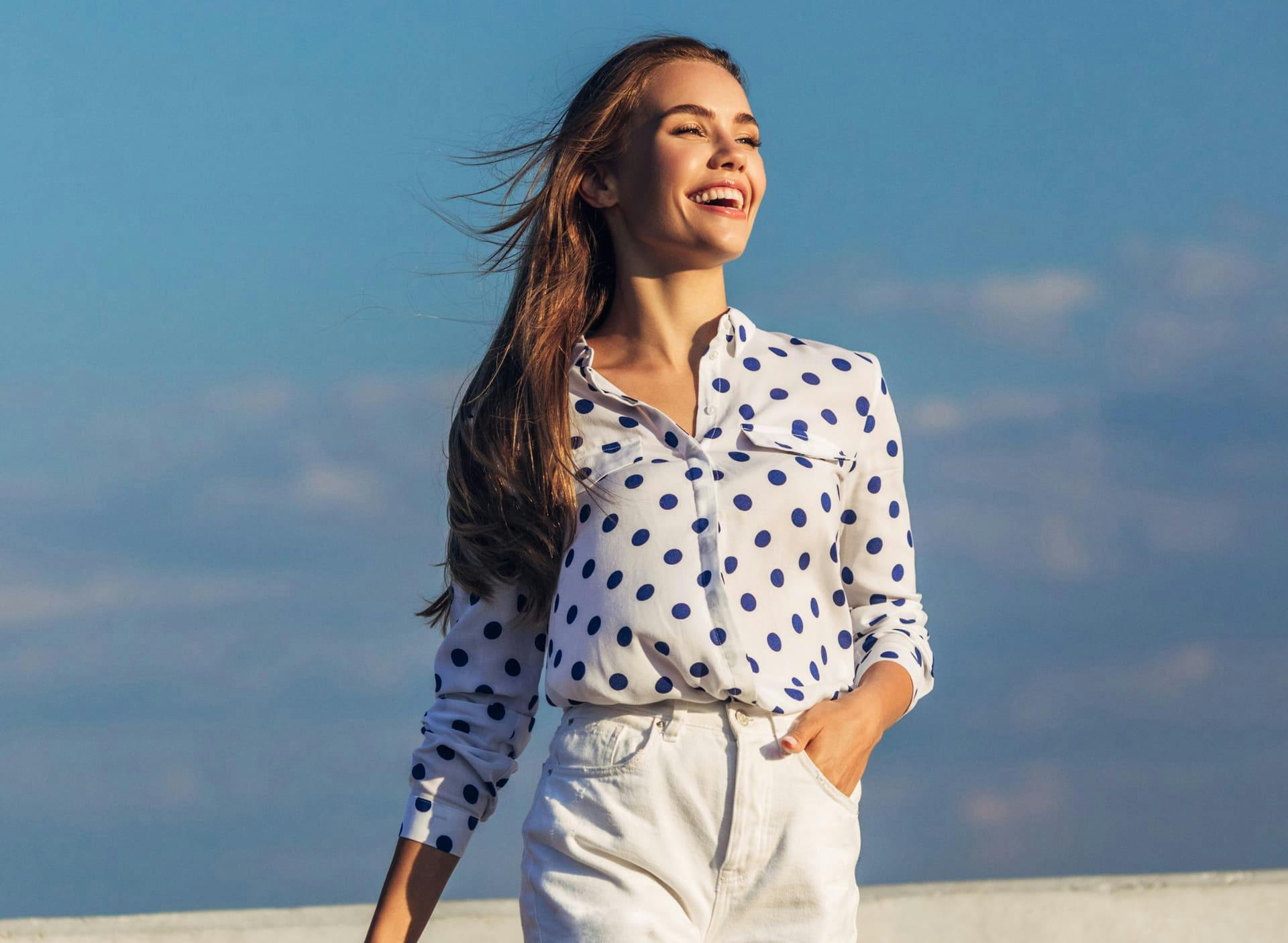 woman smiling in polka bot top