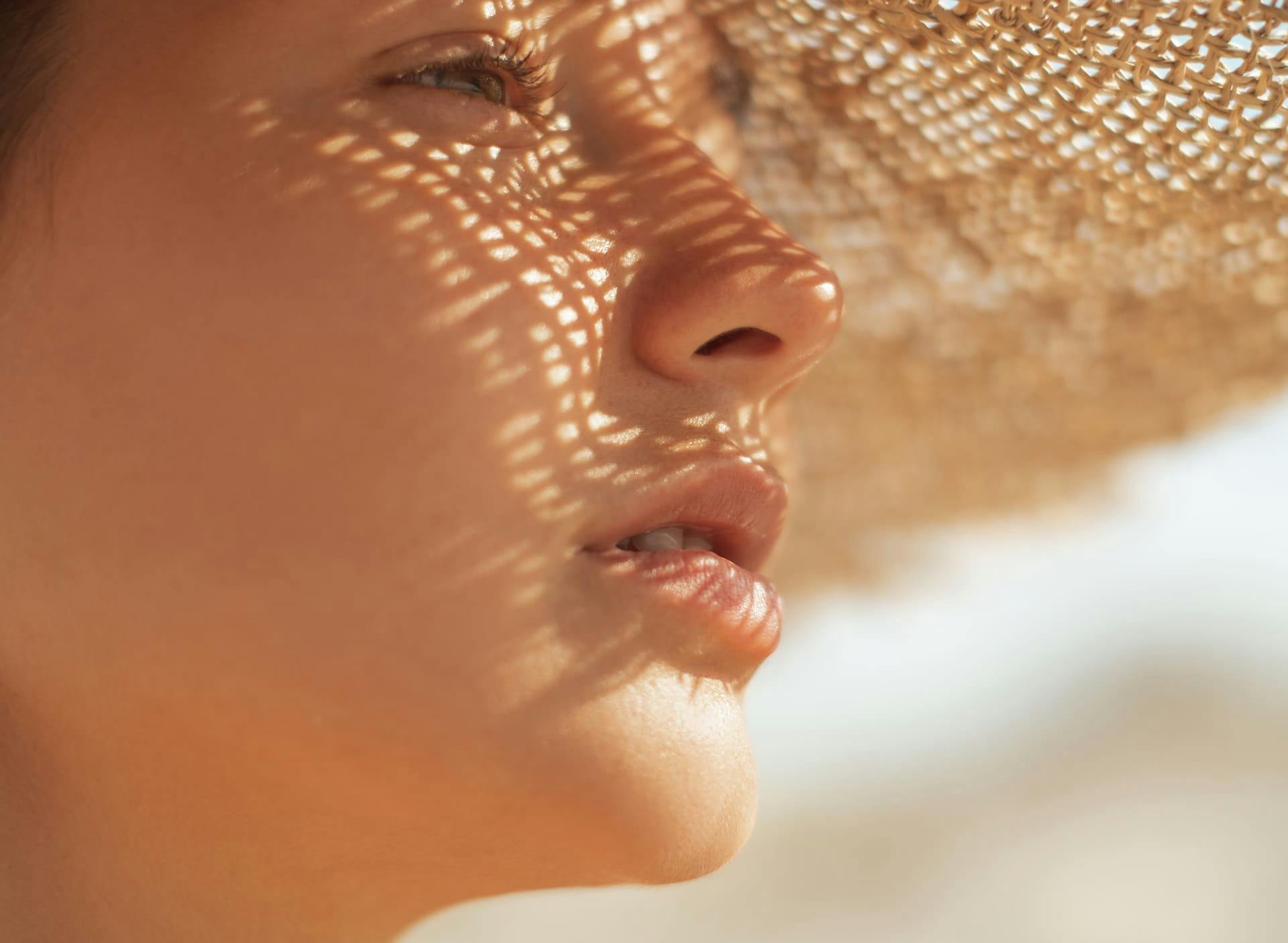 woman wearing straw hat looking to the right