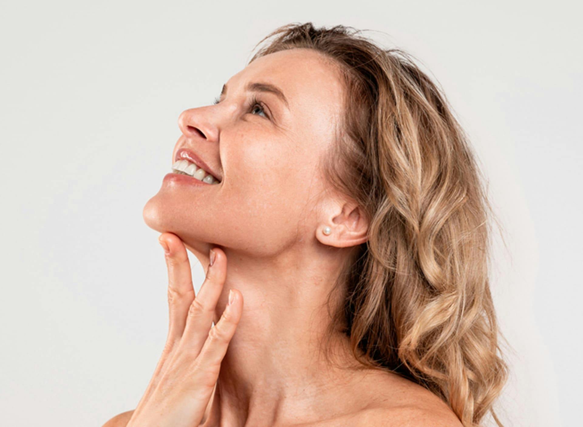 woman smiling with her head tilted upwards