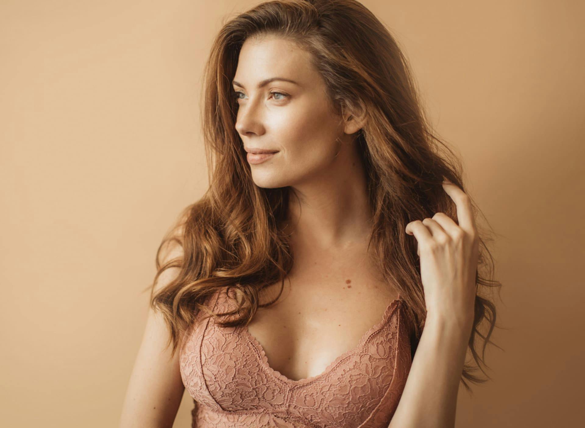 woman looking to the left in beige bra