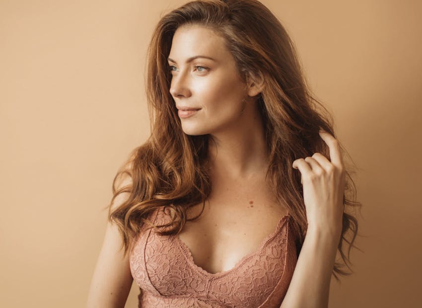 woman looking to the left in beige bra