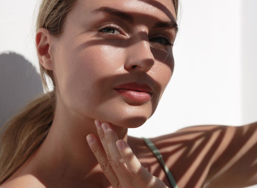woman with shade on her face with low ponytail