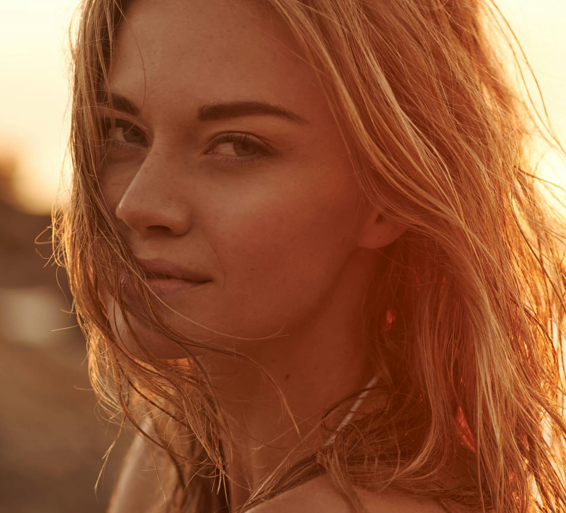 woman looking forward with wet hair on the beach