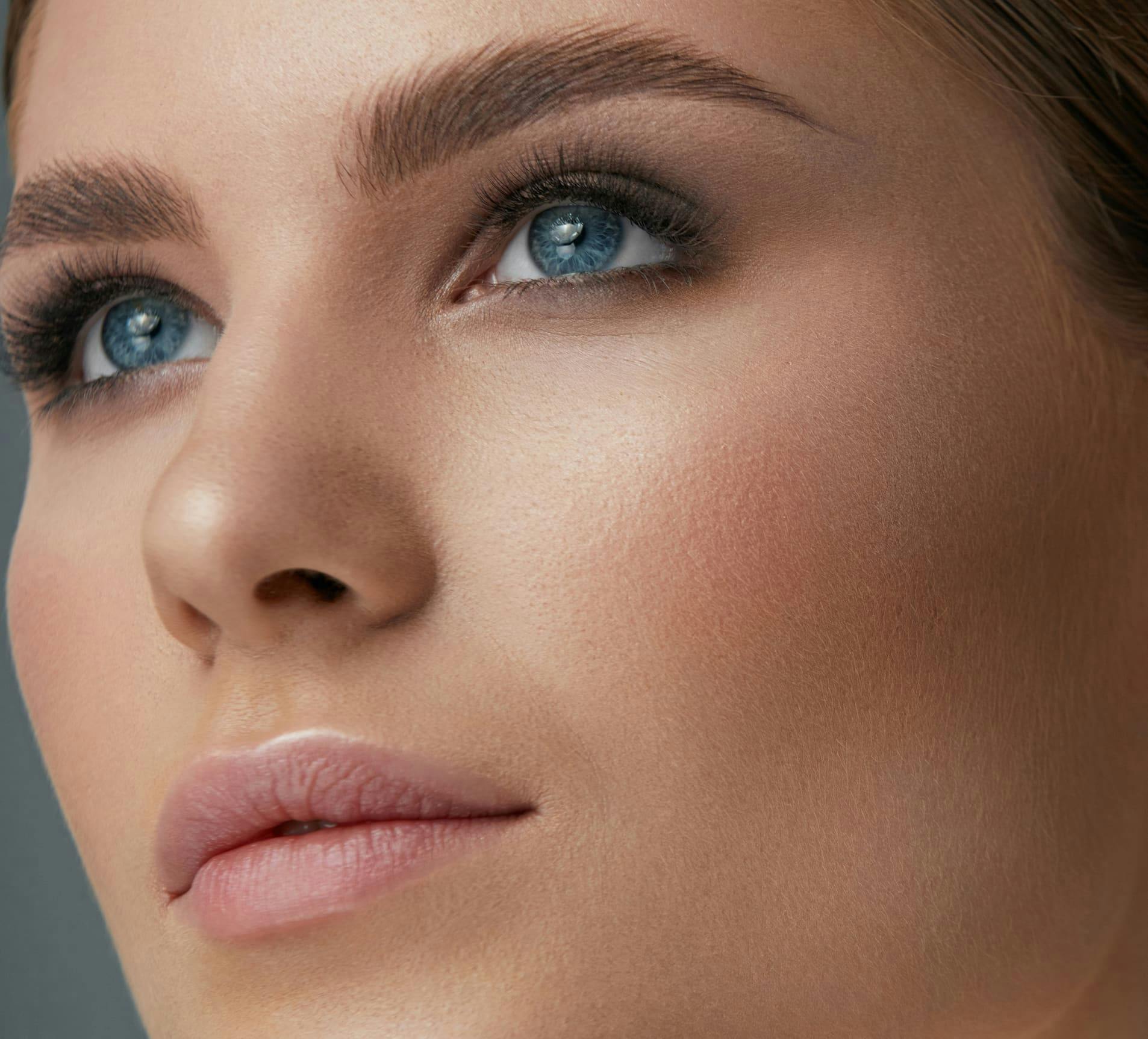 close up on woman's face looking upwards slightly