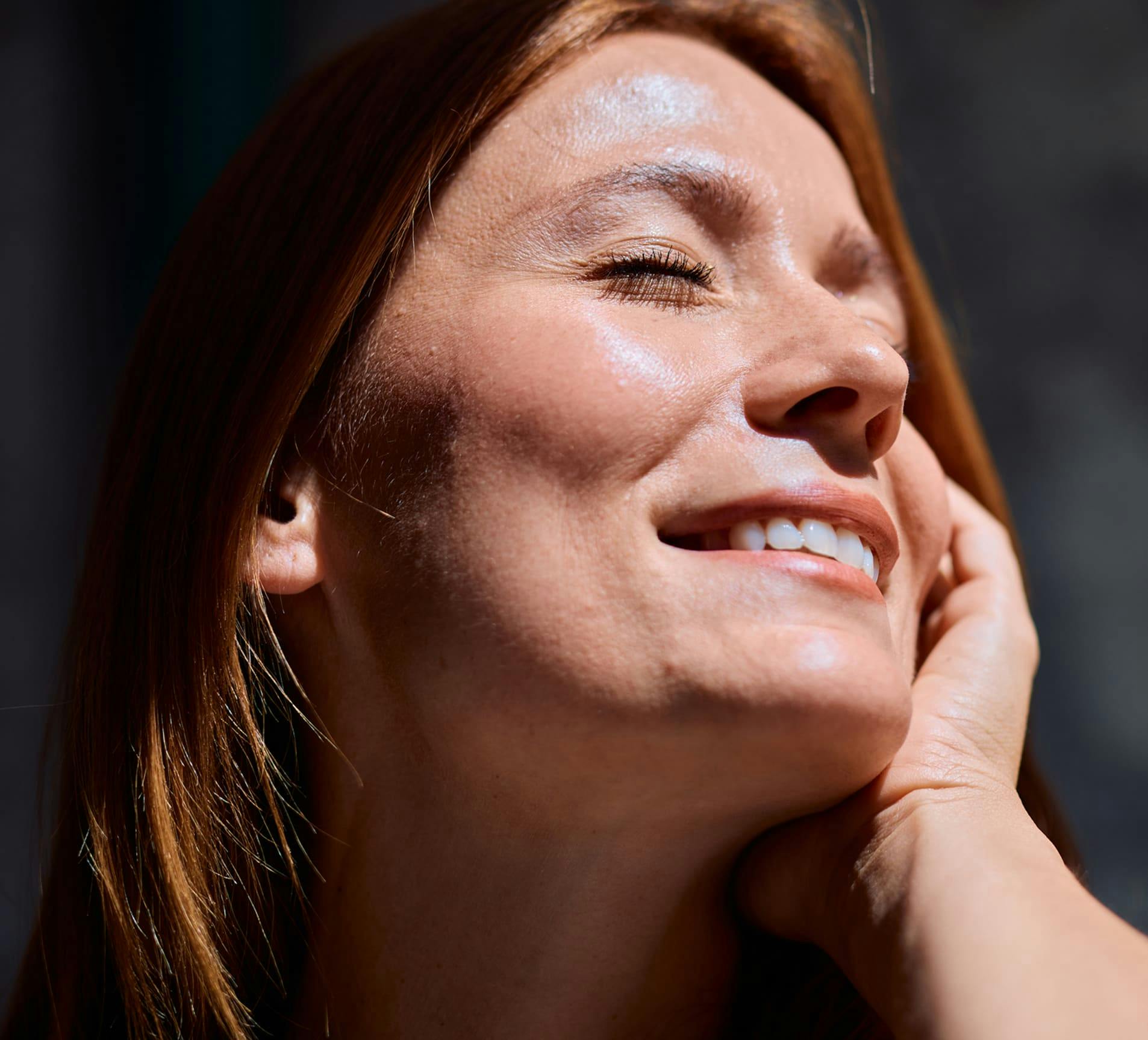 woman smiling with sunlight on her face