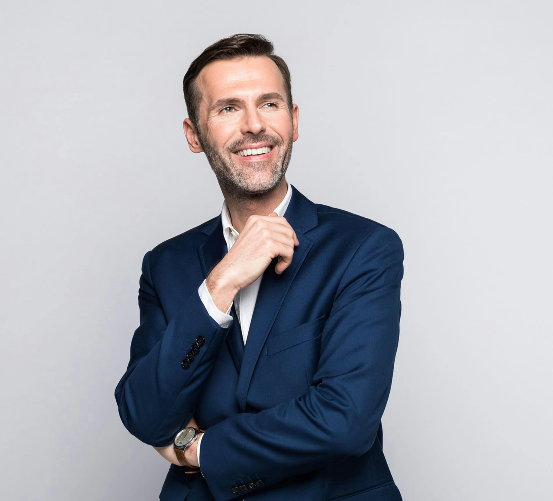 man smiling in blue suit