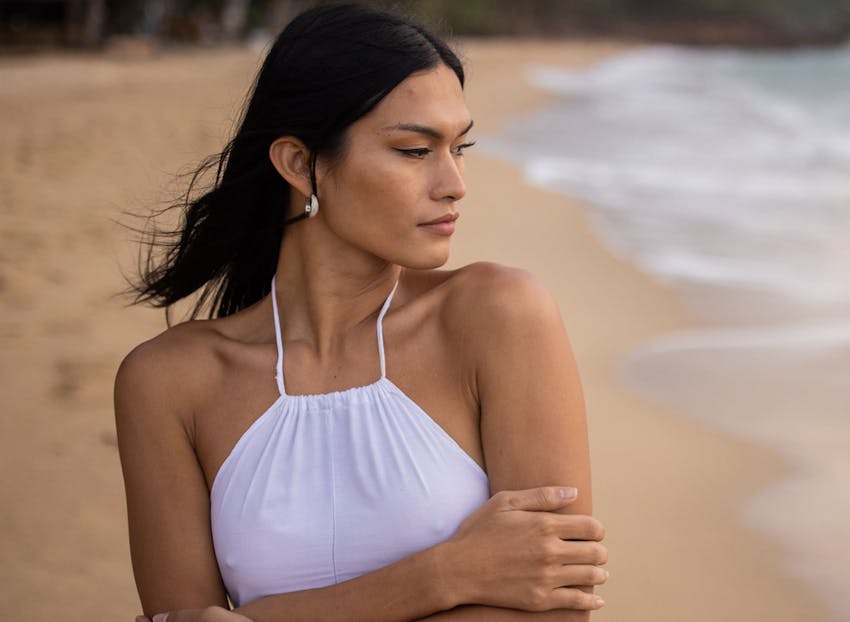 woman on the beach with her arms crossed