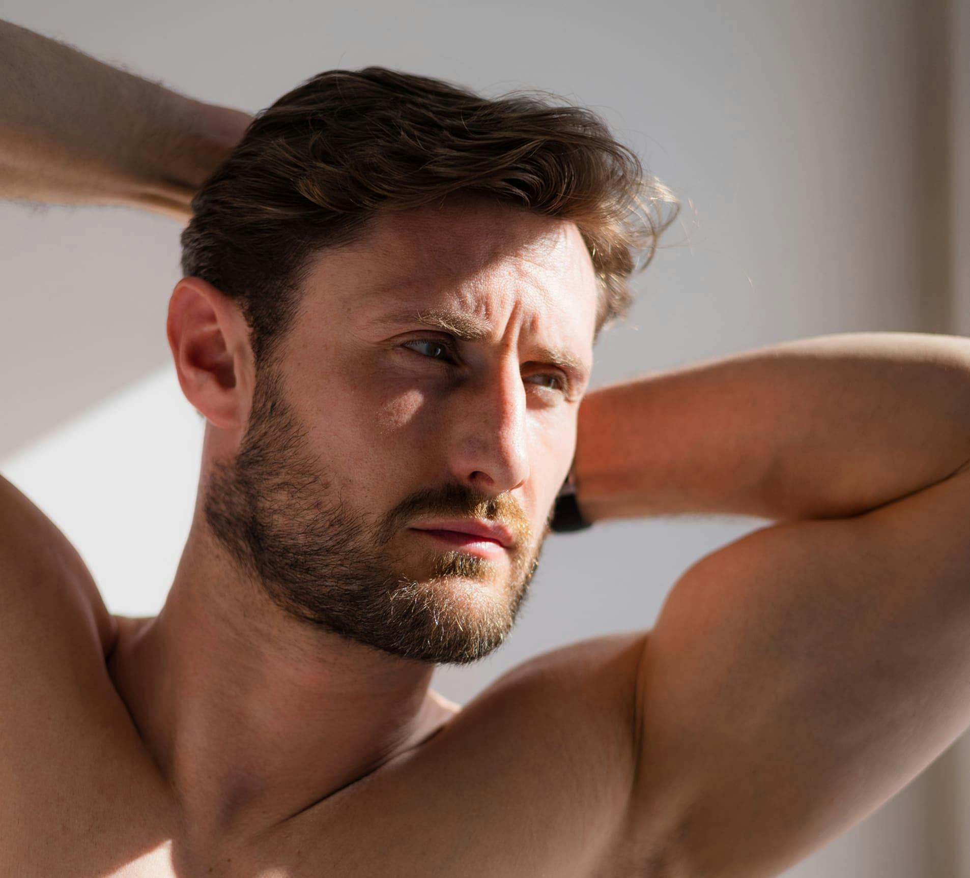 man with his hands behind his head