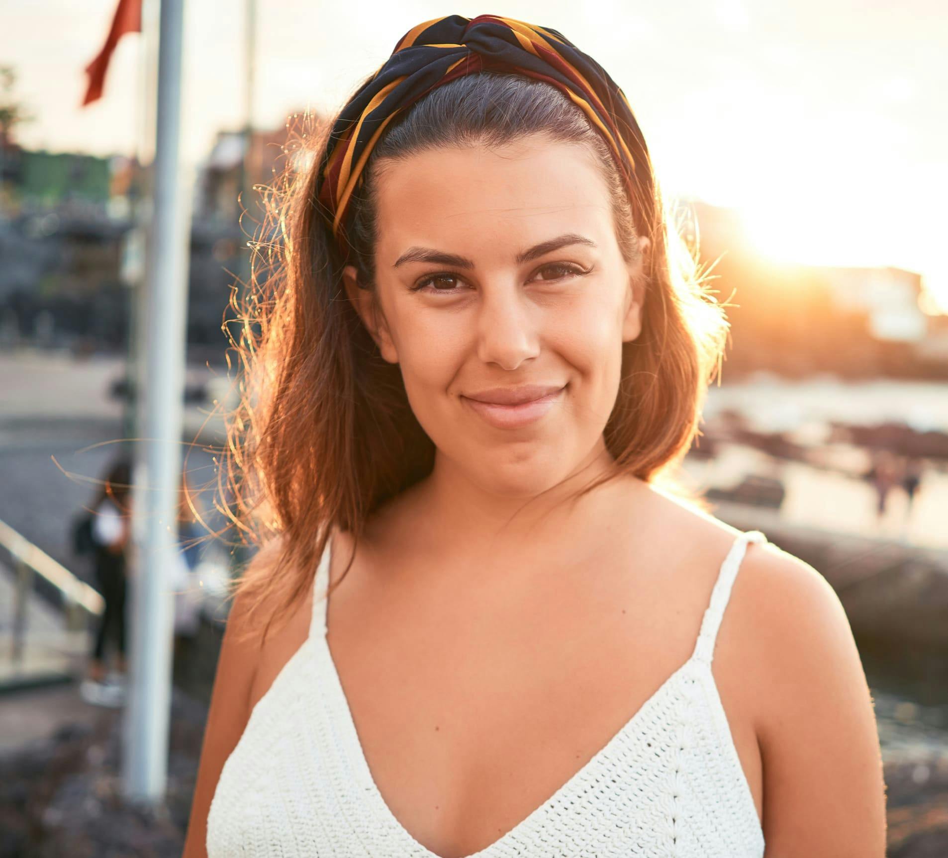 woman with high pony tail in white tanktop