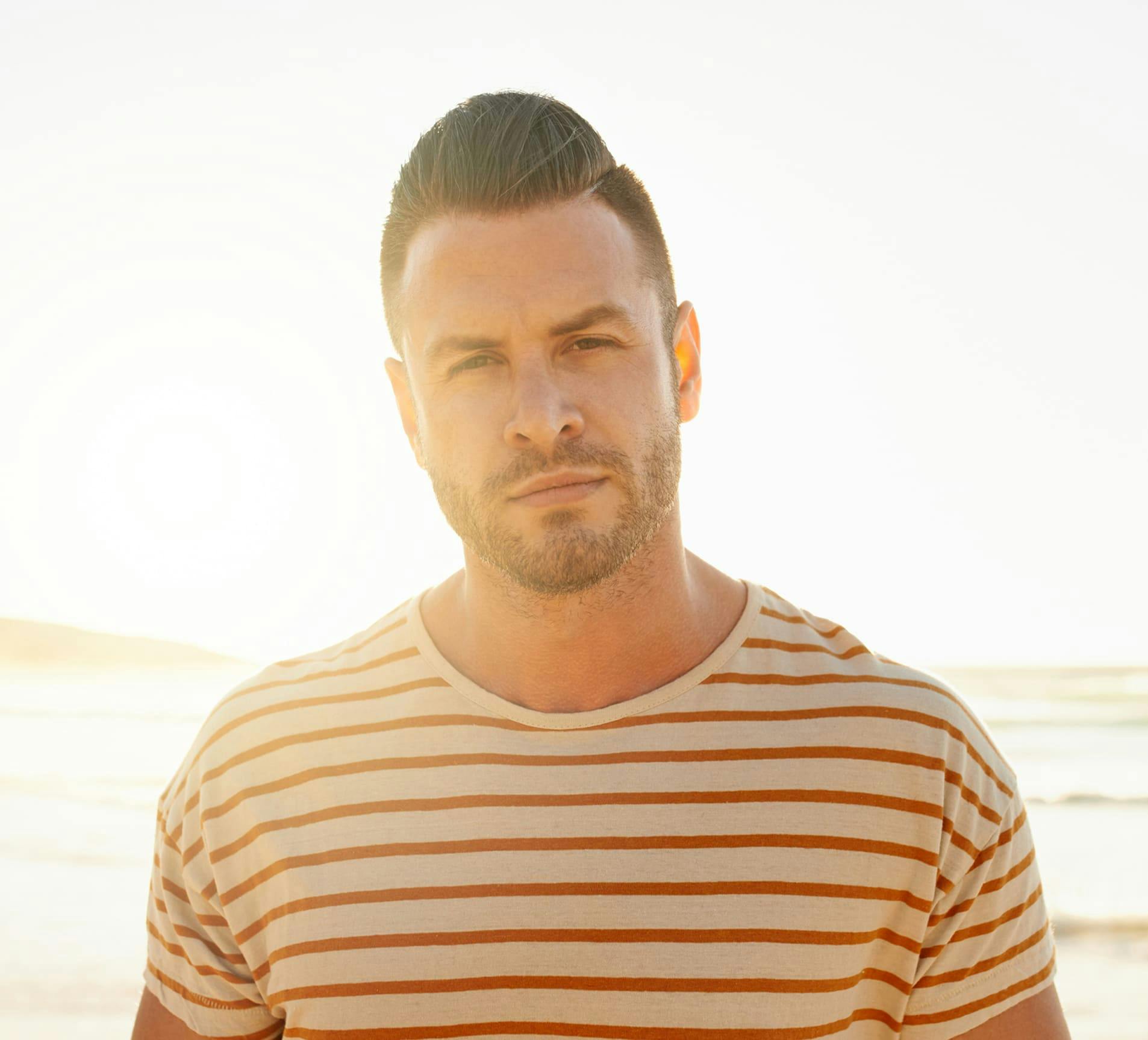 man in striped shirt looking forward
