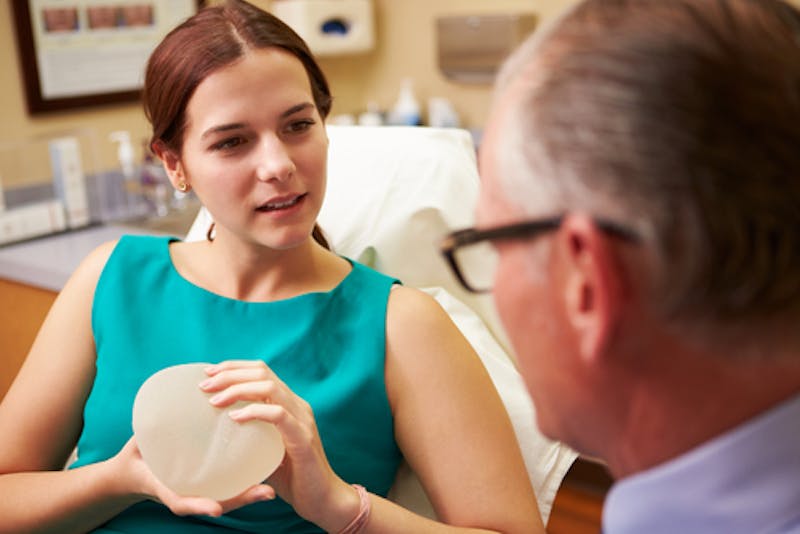 woman talking to doctor about breast augmentation