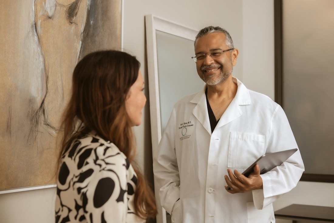 Dr. Batra talking with a patient in a consultation room