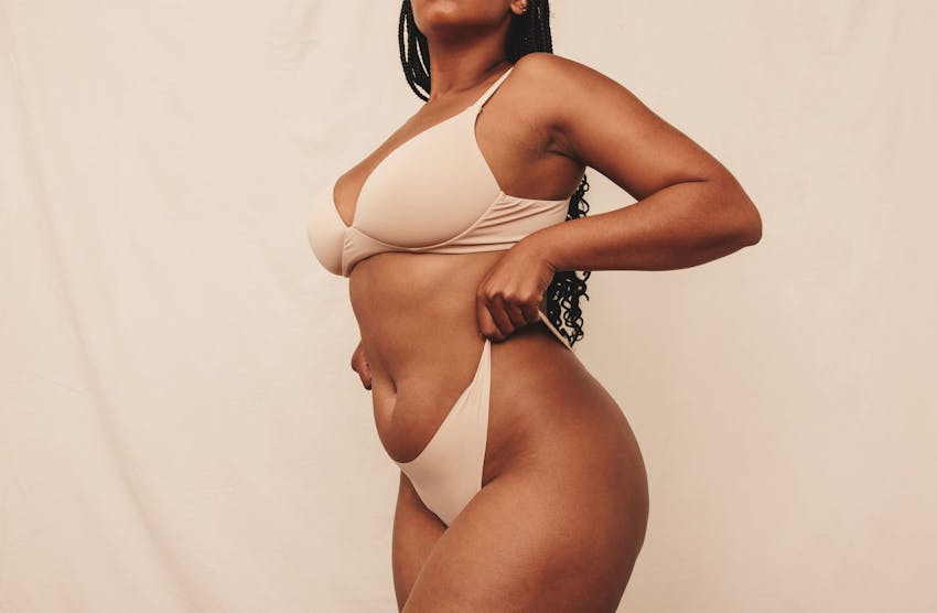 woman lifting the sides of her underwear up