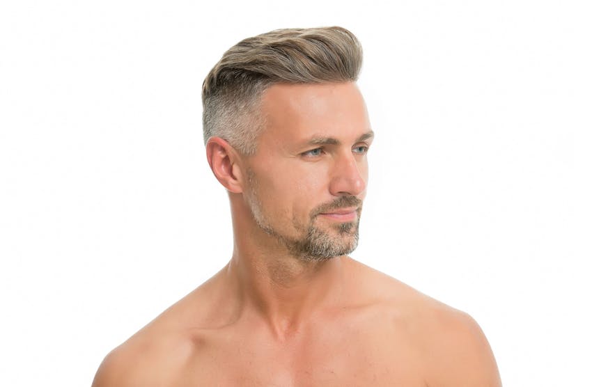 older man looking to the right with his hair brushed back
