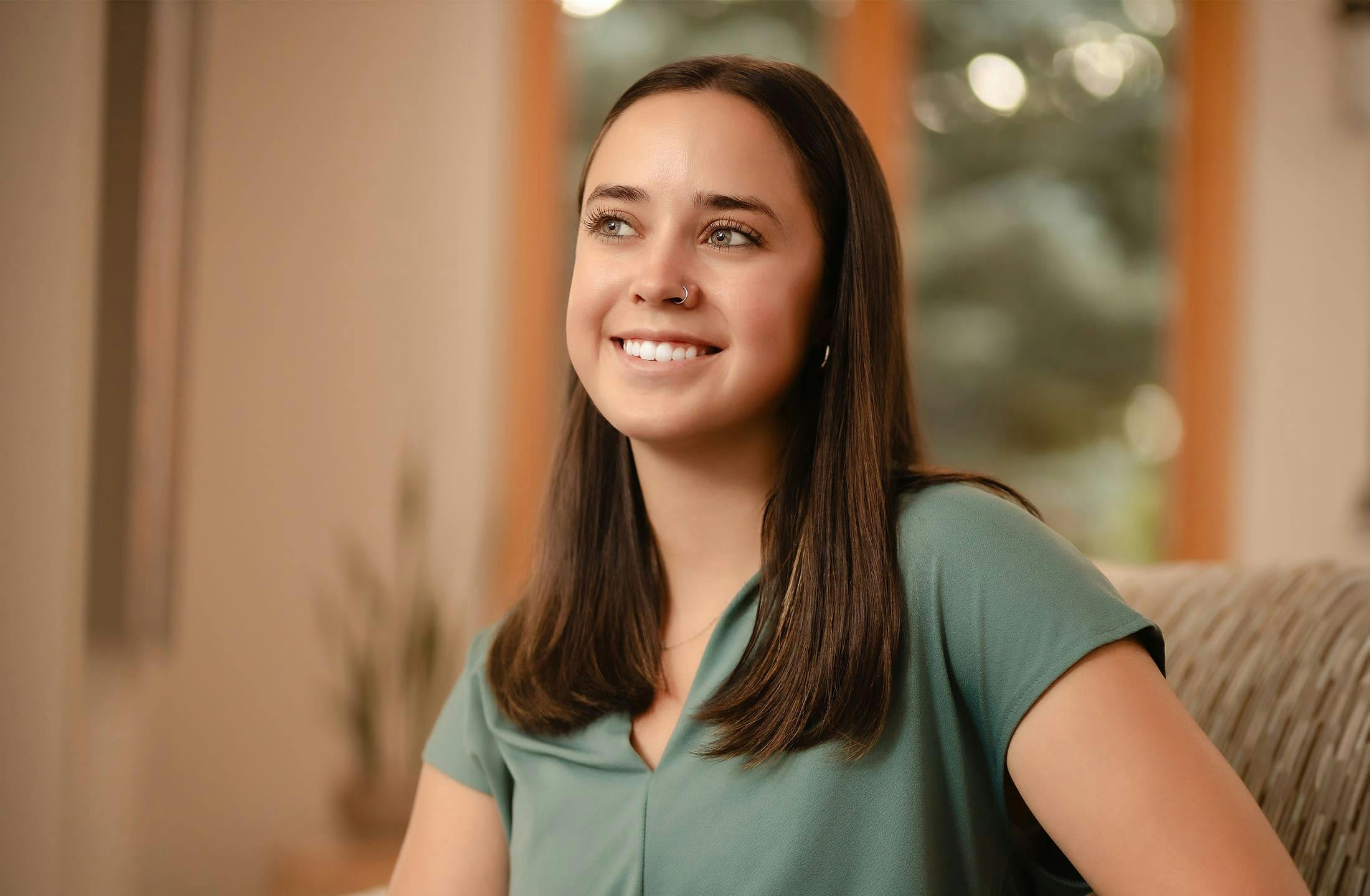 woman smiling and sitting on couch