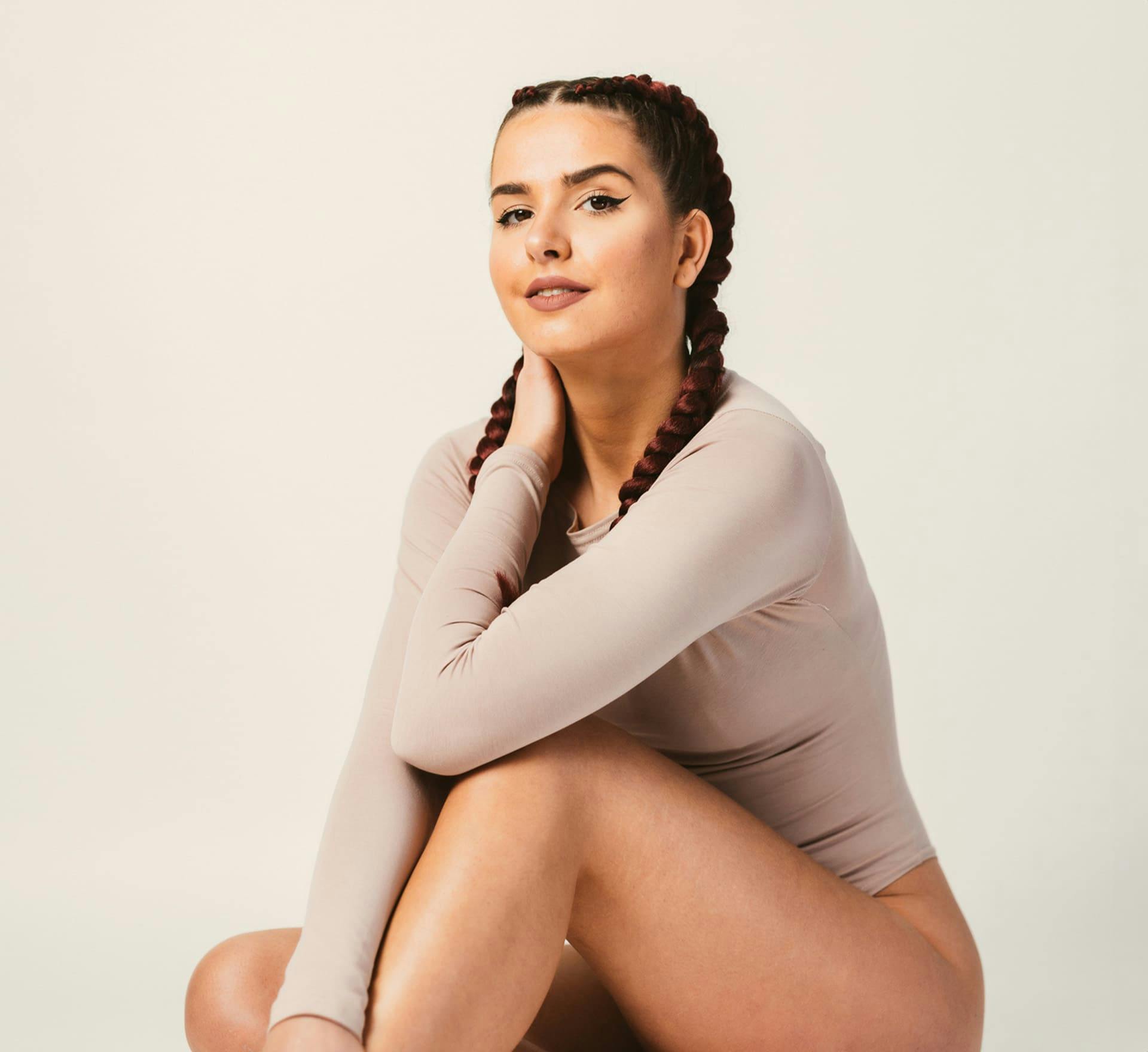 woman with her hair in french braids in long sleeve