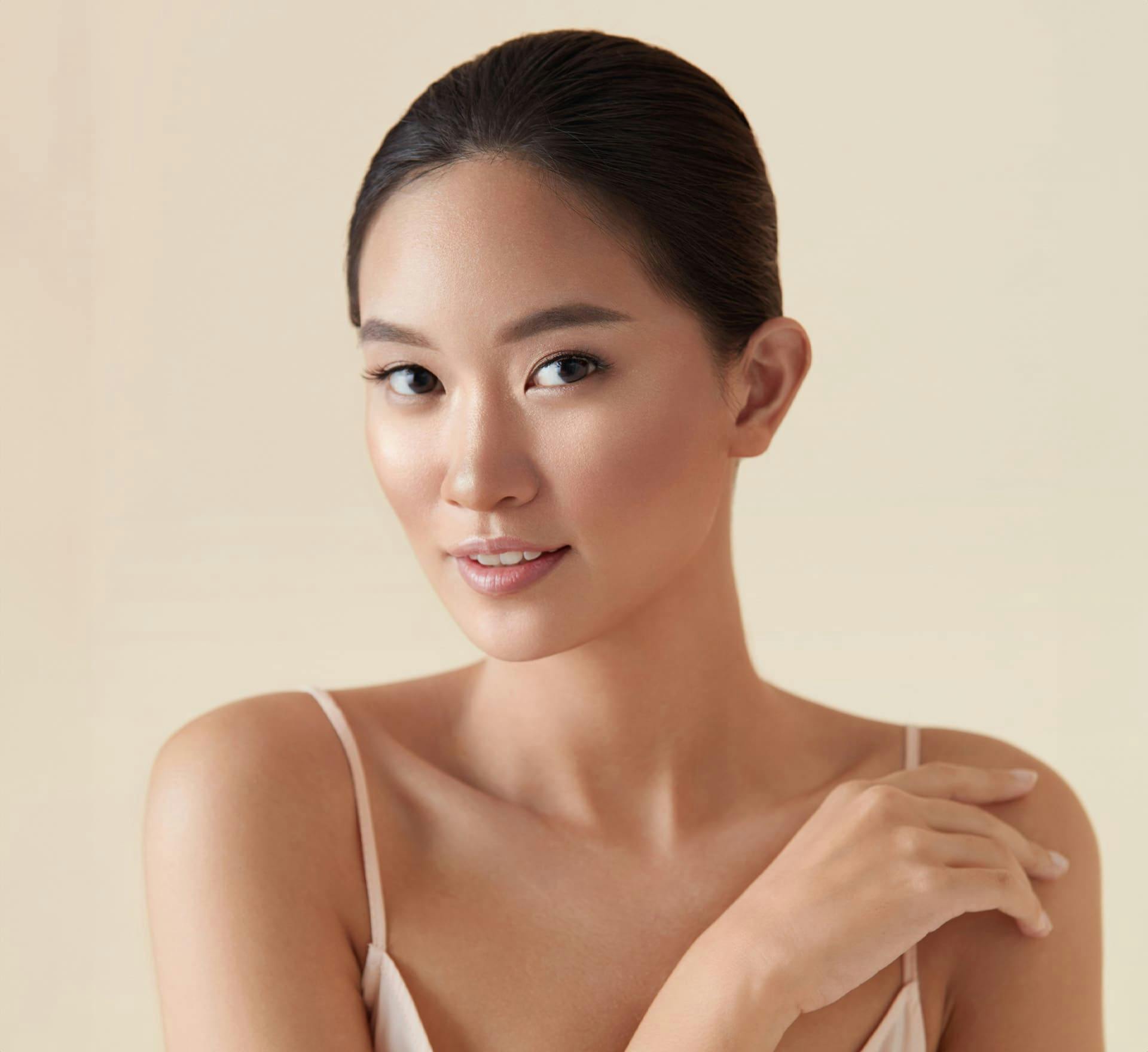 Woman smiling and touching shoulder