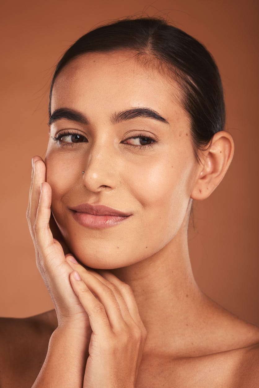 woman smiling with hands on her face