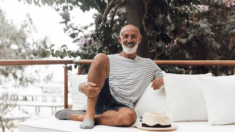 person, sitting, adult, male, man, balcony, shoe, face, head, cushion