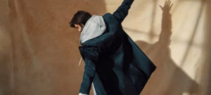 clothing, coat, cape, dancing, person, adult, female, woman, suit, blazer