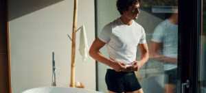 clothing, undershirt, shorts, person, adult, male, man, t-shirt, white board, bathing