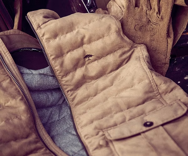 clothing, vest, coat, lifejacket, jacket, glove, baby, person