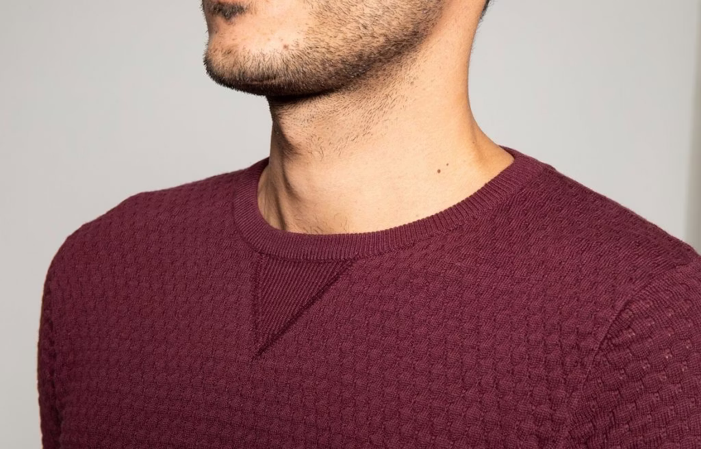 clothing, knitwear, sweater, body part, face, head, neck, person