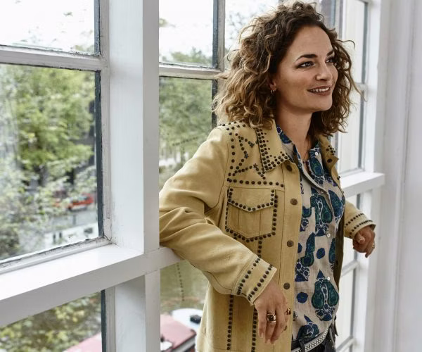 adult, female, person, woman, curly hair, hair, coat, ring, face, head
